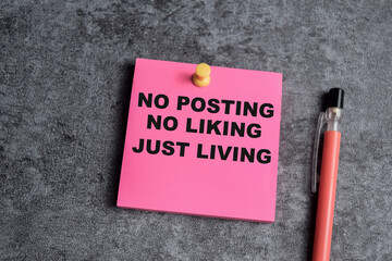 Concept of No posting, No liking, Just living write on sticky notes isolated on Wooden Table.