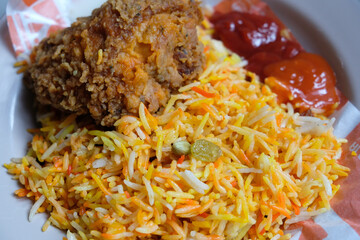 Close-up of kebuli rice and crispy fried chicken