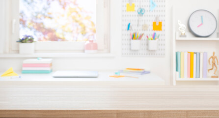 Fototapeta na wymiar Blank wooden board for product display on blurred schooler table and room interior background