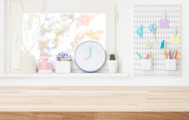 Fototapeta premium Empty wooden table top for product display on blurred schooler room window sill interior background