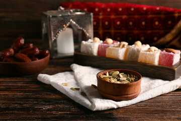Pumpkin seeds, Turkish delight and dates on wooden table. Ramadan celebration