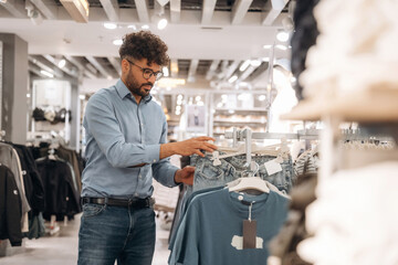 Blue jeans. Man customer is in the clothing store