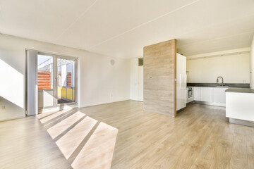 A contemporary minimalist interior design featuring an open space with ample natural light, wooden...