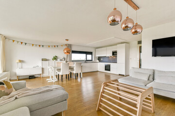 A spacious, modern living room featuring stylish furniture, a well-lit kitchen, and elegant decor...