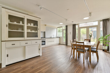 Bright and spacious dining area features wooden flooring, sleek cabinetry, and ample natural light,...