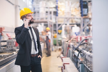 Quality inspectors team and workers at factory using machines