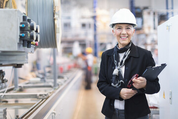 Quality inspectors team and workers at factory using machines