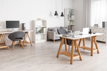 Interior of lawyer's office with desks, sofa and shelf units