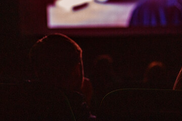 watching a new movie premiere at the cinema with children. family day out