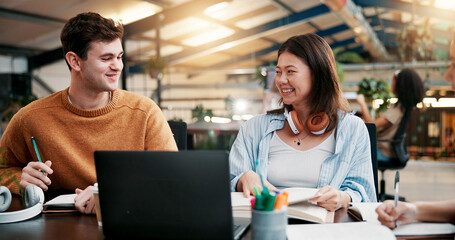 Students, laptop and team learning in library for education, help or brainstorming in college. Computer, happy people or group in university for research project on textbook, study or exam discussion