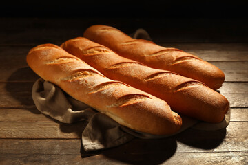 Fresh baguettes on wooden table