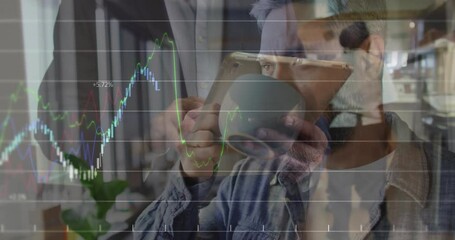 two men holding tablet and phone, sipping coffee, displaying finance chart overlay with trend line