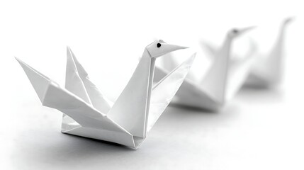Naklejka premium Three origami swans in a row