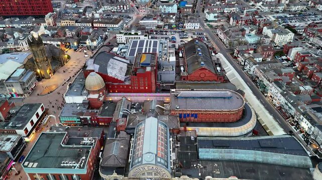 High aerial drone view capturing Blackpool's iconic Winter Gardens complex and surrounding town centre at dusk