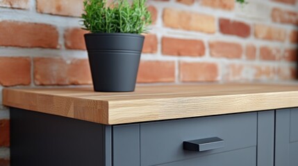 Close-up of a modern gray cabinet countertop with a light wood edge.