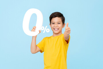 .Cheerful mixed race Asian boy smiling and giving thumbs up holding 0% number, zero interest rate installment payment concept