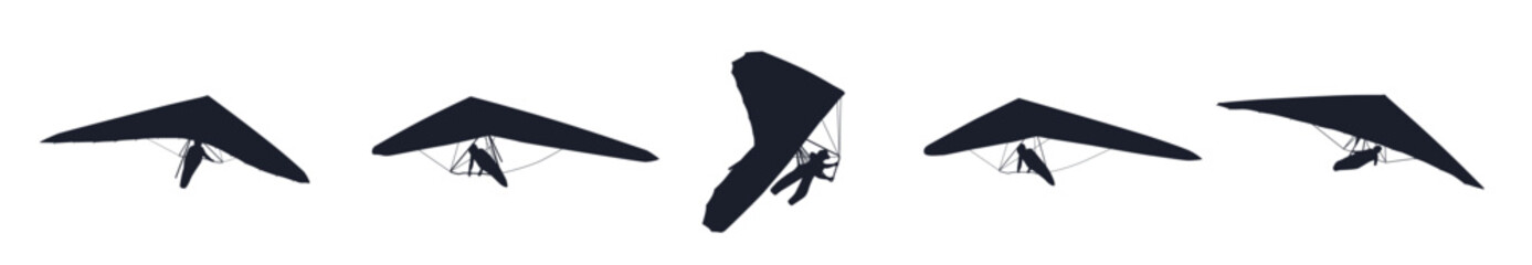 Black silhouettes hang glider or parachute skydiving