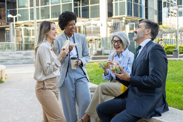Business people having lunch break together outdoors