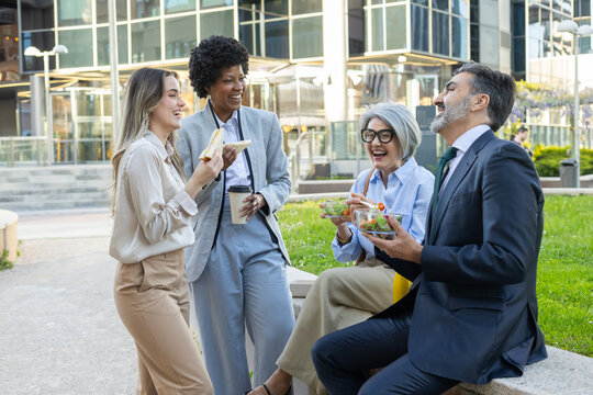 Business people having lunch break together outdoors