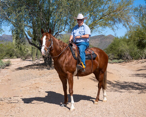 A cowboy riding his horse in Arizona