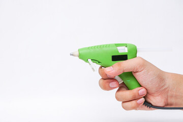 Hot glue gun for repair in master man hand isolated on white background