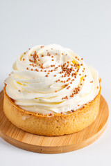 Lemon tartlets with whipped cream, sprinkles and chocolate chips on white background