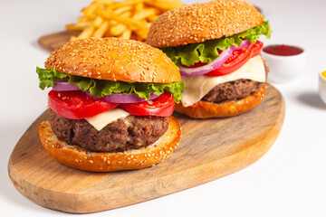 Hamburger made of beef, onion, tomato, lettuce, cheese and spices. Fresh burger closeup. Cheeseburger.