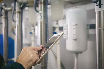 Senior maintenance engineer checking the system in the boiler room