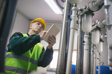Senior maintenance engineer checking the system in the boiler room