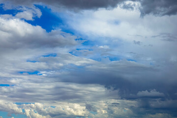 Full frame photo of dark cloud covering blue sky with copy space. Rainy season scenery before rain pouring down
