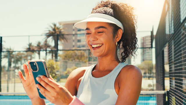 Tennis, happy and woman on court with phone, social media or scroll on training app for exercise tips. Athlete, smile or mobile on sports ground for tournament results, fitness or club registration