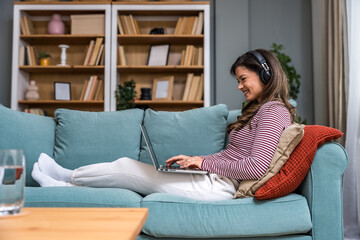 Young woman former victim of domestic violence relax in her apartment has a video call on laptop computer explain and talk about how to reclaim life and have strength to let go of toxic relationships.