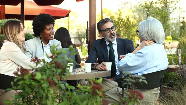 Business people having a lively discussion at outdoor cafe