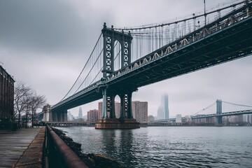 Fototapeta premium Foggy urban landscape featuring the Manhattan Bridge with skyscrapers in the background