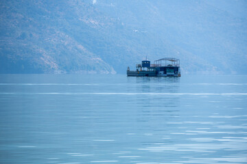 A floating hotel in the lake provides a unique and luxurious stay. The surrounding waters create a calming environment for guests.