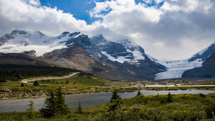 Fototapeta premium Majestic mountain landscape featuring glaciers and a winding road in Columbia Icefield during the day