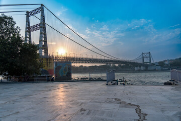 A view of the Janki Setu bridge from across the River Ganges shows the river flowing down. This picturesque scene highlights the beauty of the area.