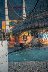 The painted walls of the Janki Setu bridge pillar in Rishikesh add color and character to the structure. The artistic display attracts visitors.