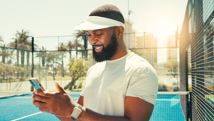Man, phone and happy at tennis court for sport, texting or contact on break for training in summer....