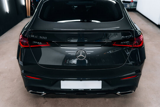Rear view of Mercedes-Benz GLC 300 4MATIC Coupe X254 in detailing studio &ndash; sleek black finish, LED taillights and luxury styling captured for premium promo, advertising and automotive content.