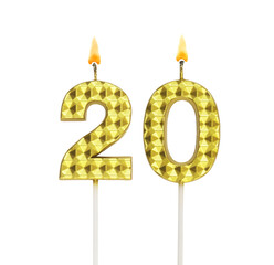 Burning gold birthday candles isolated on white background, number 20.	
