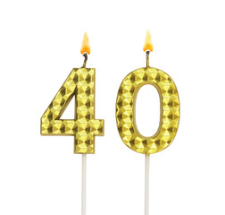 Burning gold birthday candles isolated on white background, number 40.	
