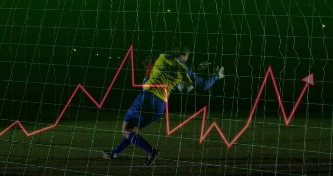 Goalkeeper diving on soccer pitch at night, capturing ball while showing sports tech chart overlay