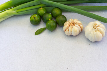 Fresh Organic Garlic, Green Calamansi, and Scallions, Perfect for Healthy Food Concepts