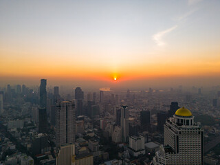 Bangkok cityscape at beautiful sunrise. Silhouette of skyscrapers in early morning haze