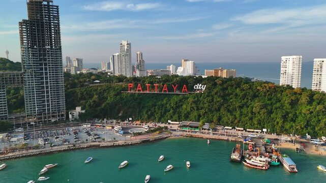 Pattaya City famous sign stands on coastal park hill slope