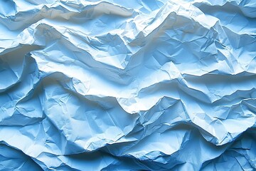 Fototapeta premium Crumpled blue paper texture abstract background with light and shadow effects.