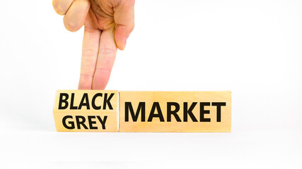 Black or grey market symbol. Concept words Black market or Grey market on beautiful wooden blocks. Beautiful white background. Businessman hand. Business black or grey market concept. Copy space.