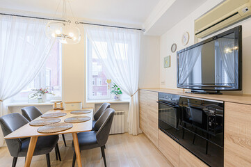 interior apartment kitchen and dining room, refectory area, cooking equipment, table furniture, stove
