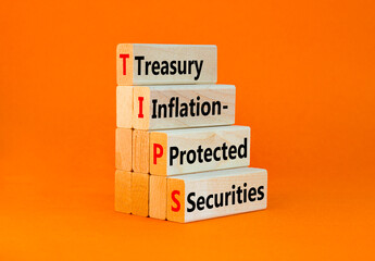 Naklejka premium TIPS symbol. Concept word TIPS Treasury Inflation Protected Securities on beautiful blocks. Beautiful orange background. Business TIPS Treasury Inflation Protected Securities concept. Copy space.
